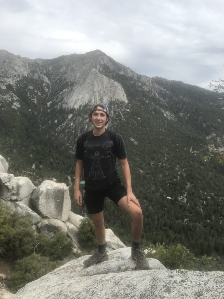 Anthony standing on suicide rock, one of the foundational trips I've taken for my own Personal Growth